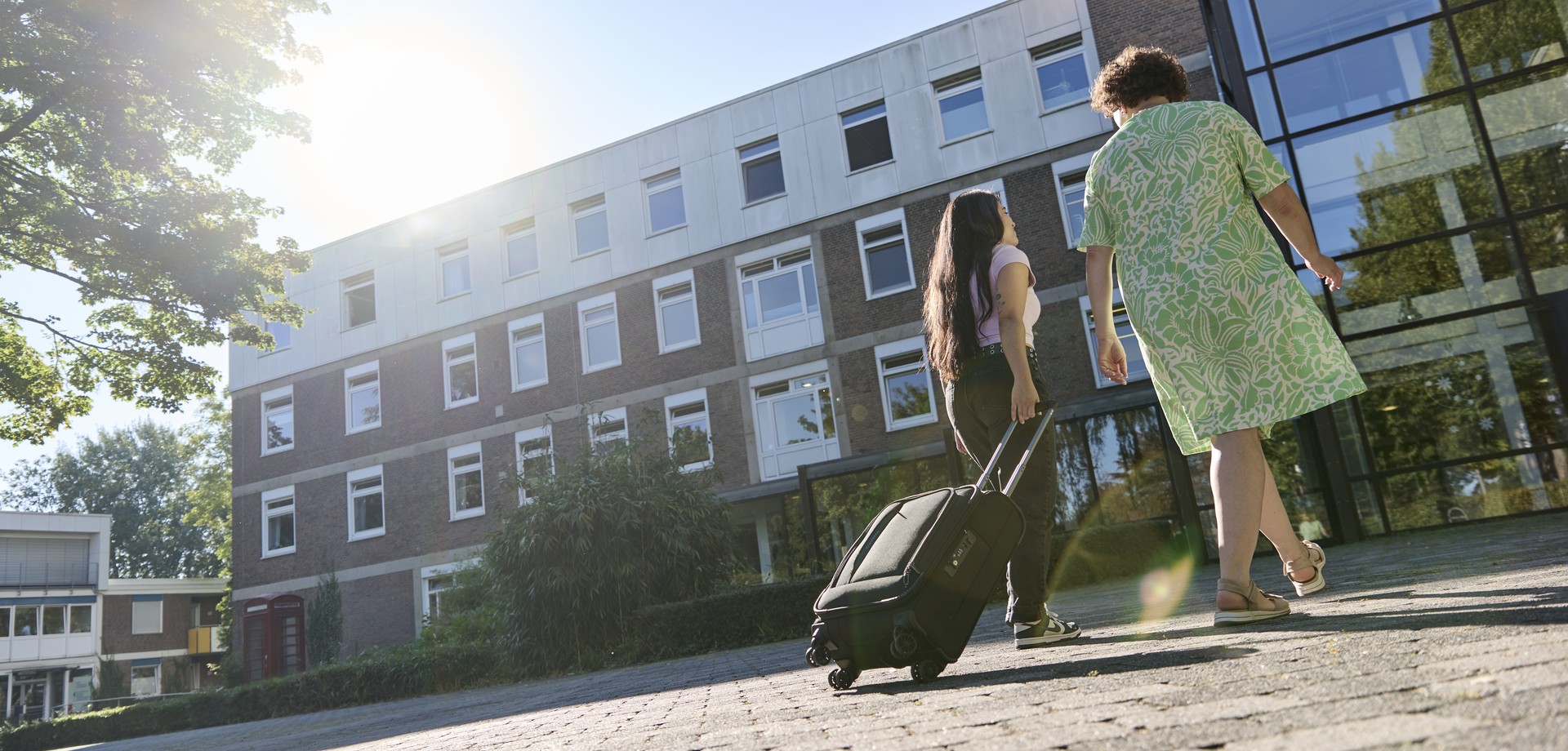 Eine Mutter und ihre Tochter gehen in ein Gebäude